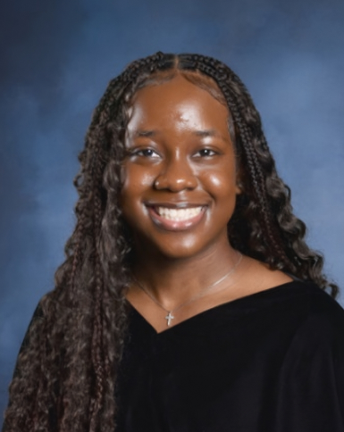 picture of me, darkskin in a black top with a cross necklace smiling.